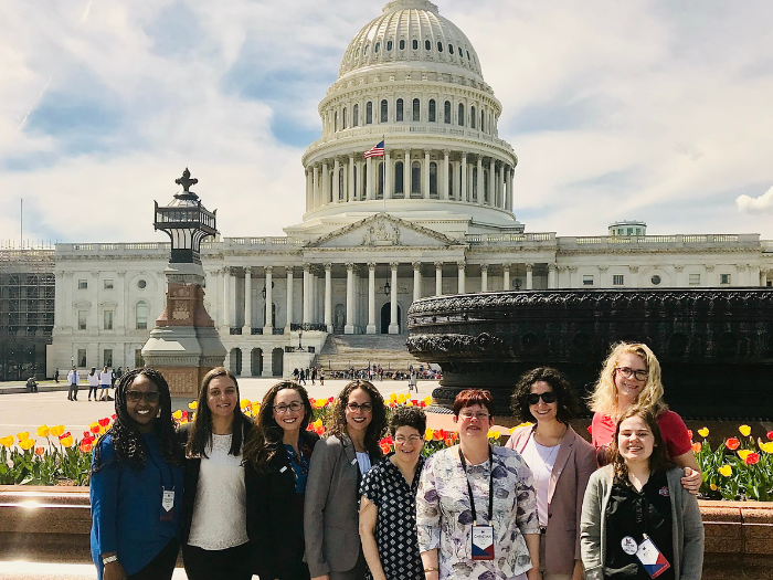 A group of students posing in front of the White House.