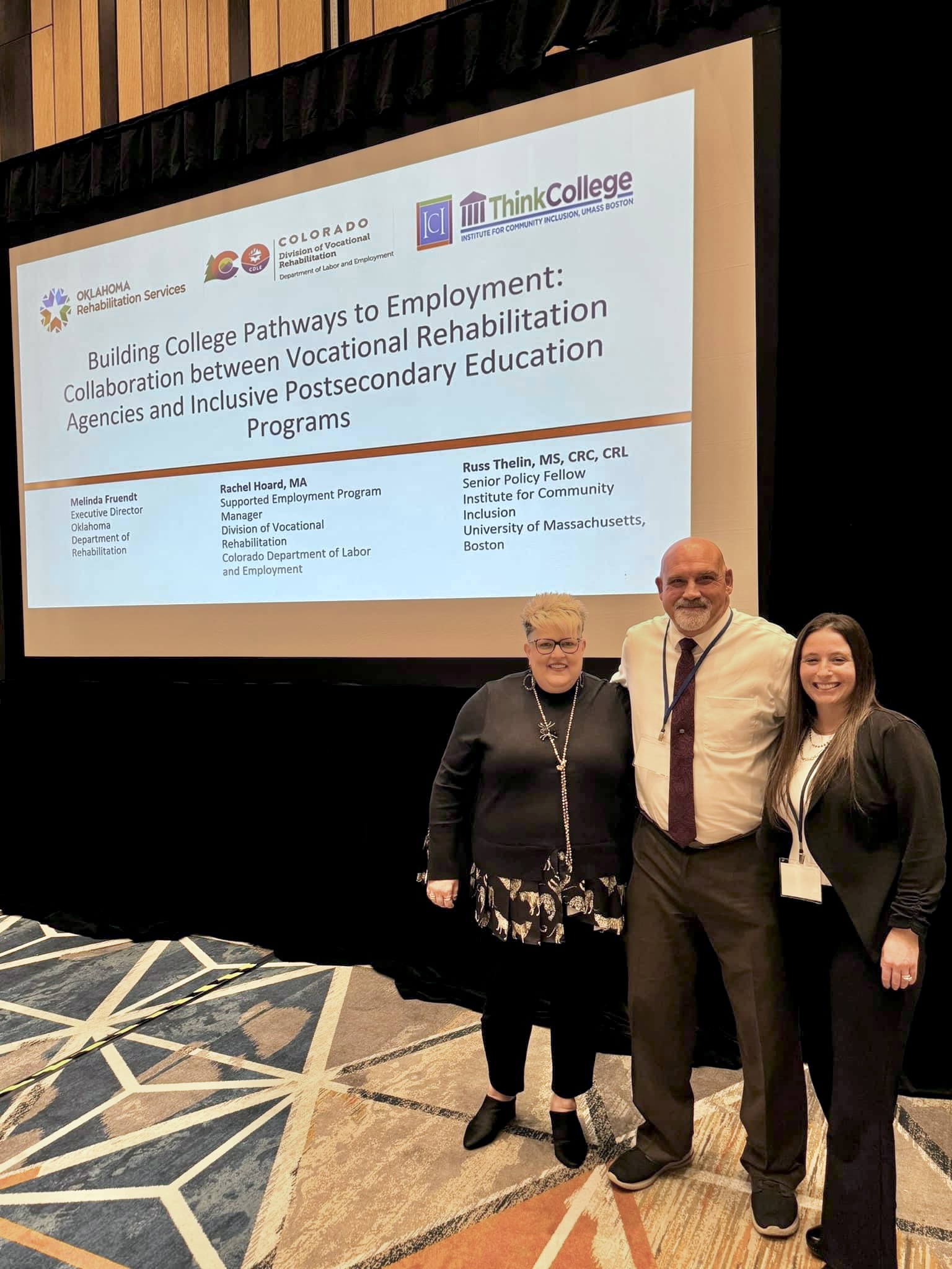 Three people standing in front of a large screen projecting a conference presentation called Building College Pathways to Employment: Collaboration between Vocational Rehabilitation Agencies and Inclusive Postsecondary Education Programs