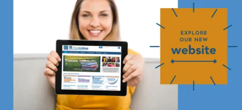 Person holding a sign that says 'Explore our new website'