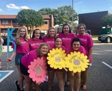 Young women, including some with disabilities, post with their sorority sisters.