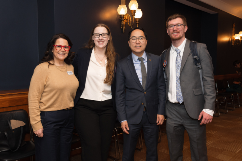 Four people standing in a hall smiling