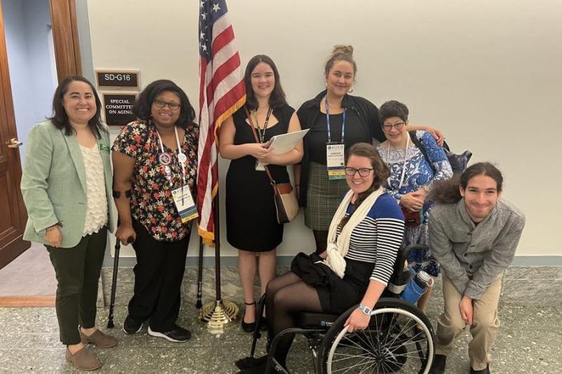 Seven people standing together, smiling, in front of SenatorBob Casey’s office in Washington, DC. 