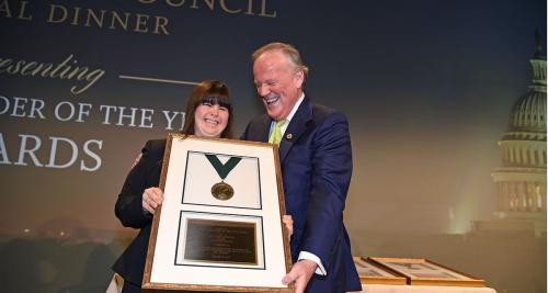 Collette Divitto gets an award from James T. Brett.