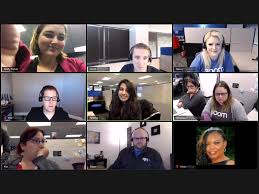 Image of computer screen with people pictured in smaller screens, using the Zoom technology