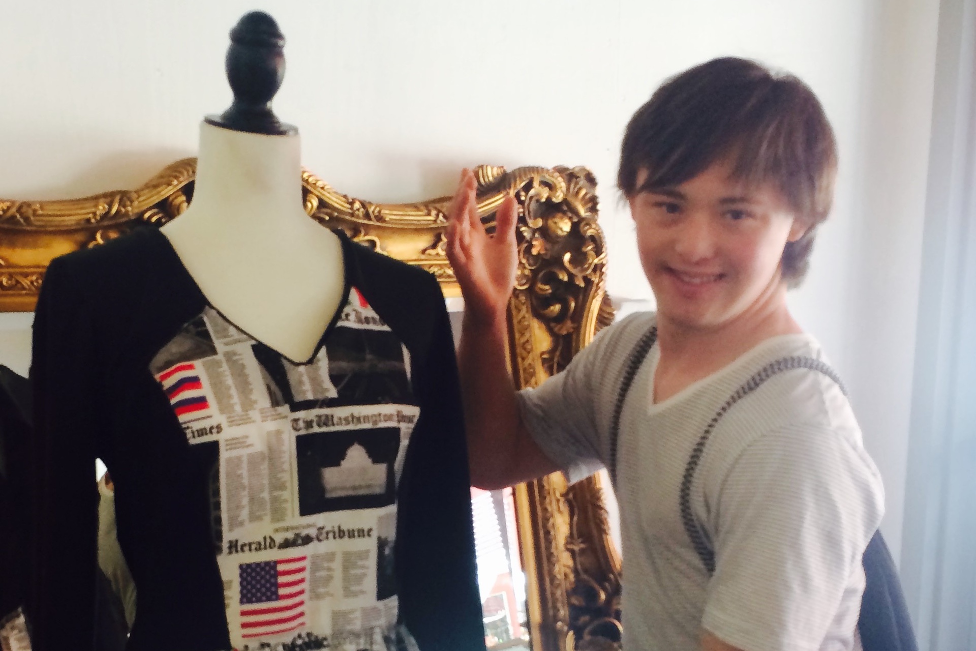 Brandon Gruber, a college student with Down syndrome, with a dress he designed.